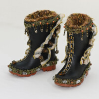 Used gumboots, fabric trim, safety pins, beads, found metal and feathers, bell, thread, wire, yarn. Each boot is 7"H x 3.25"W x 6"D, 2006 (non-wearable)