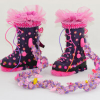 Used gumboots, faux fur, jump rope, beads, wooden blocks, sequins, fabric trim, buttons, pom-poms, plastic stars and butterflies, plastic doll shoes, ribbon, shoe heels, wool, wire, thread, eyelets, cord. Dimensions variable, 2009 (non-wearable)