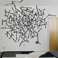 5" black zippers, used toy railroad tracks, metal snaps, 35 mm film strips, thread. Dimensions variable, 2010