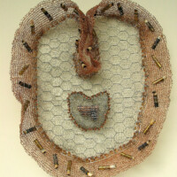 Silver, copper and brass wire, chicken wire, gun cigarette lighter, bullet casings, cigarette butts, metal edging, beads, 18"H x 16"W, 2004